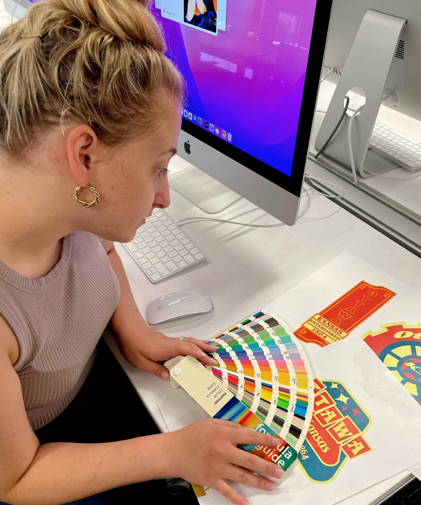 Student Viewing the Pantone Color Formula Guide to Assist with a Project