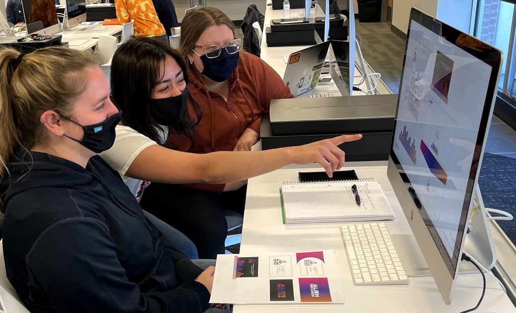 Three Students Working on a Computer Together